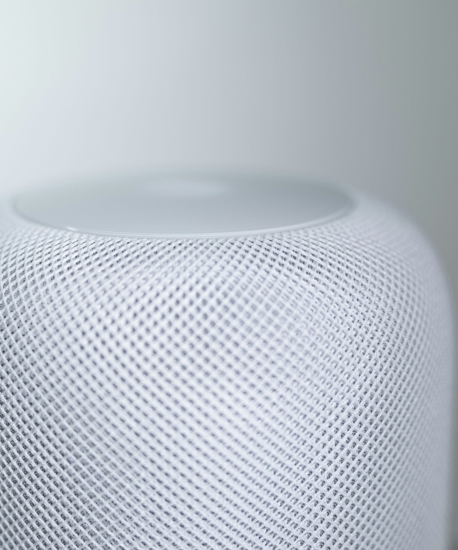 white round speaker on white table